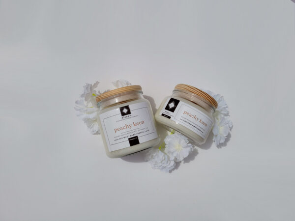 Peachy Keen soy wax candle by Alena’s with wooden lid and crackling wooden wick.