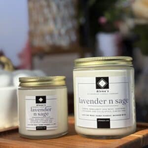 Hand-poured Lavender N Sage soy candles from Alena’s Gold Collection in 4 oz and 8 oz gold tins, featuring natural soy wax and a crackling wooden wick.