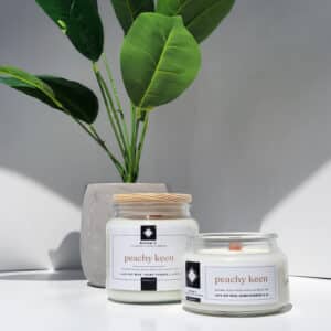 Peachy Keen soy wax candle by Alena’s with wooden lid and crackling wooden wick.