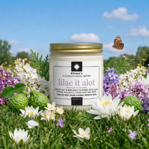 wooden wick candle on a grass and blue sky background with lilacs, and waterlily petals surrounding it